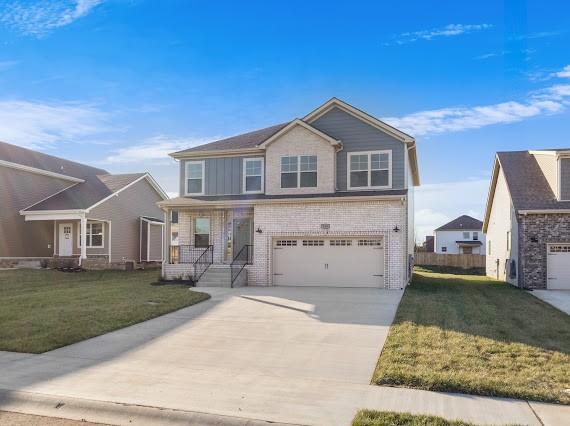 view of front of house featuring a garage and a front lawn