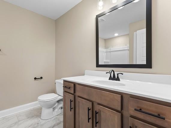 bathroom featuring a shower, vanity, and toilet