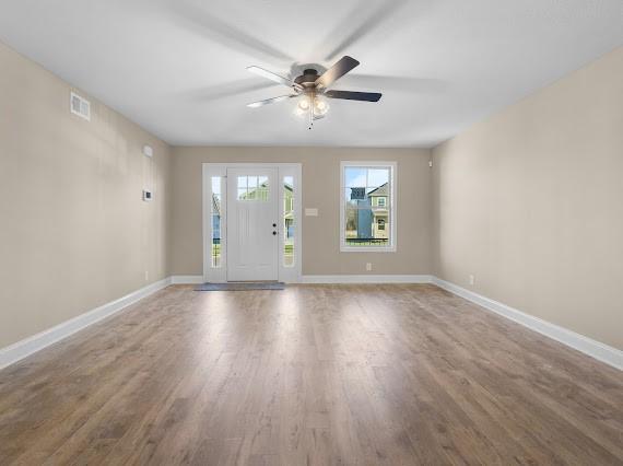 unfurnished room with hardwood / wood-style floors and ceiling fan