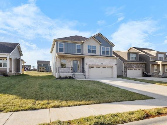 view of front of property with a garage and a front lawn