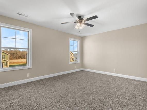 empty room featuring carpet floors and ceiling fan