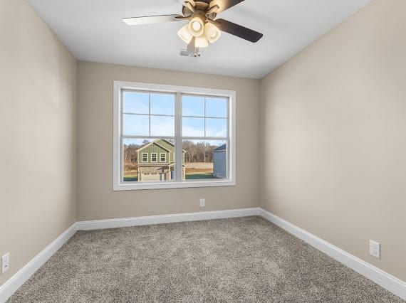 unfurnished room featuring ceiling fan and light carpet