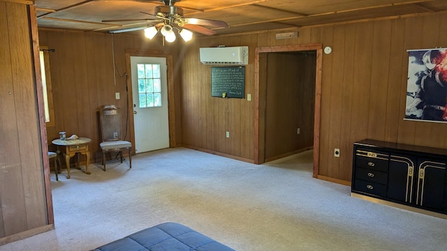 unfurnished living room with ceiling fan, light carpet, wooden walls, and a wall mounted AC