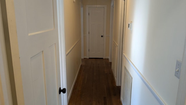 corridor featuring dark hardwood / wood-style flooring