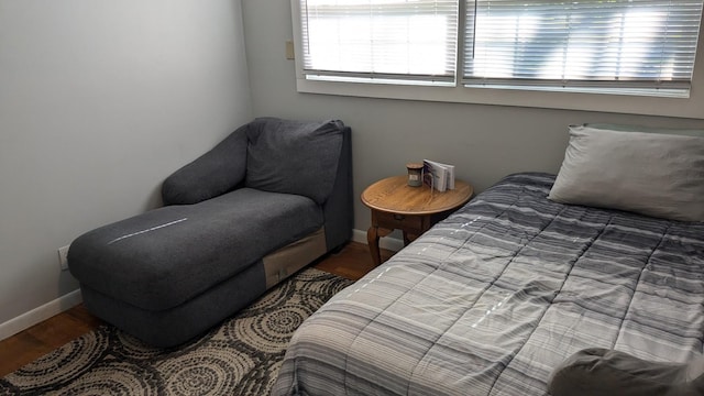 bedroom with dark wood-type flooring