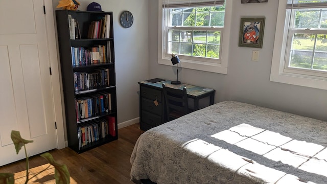 bedroom with dark hardwood / wood-style flooring