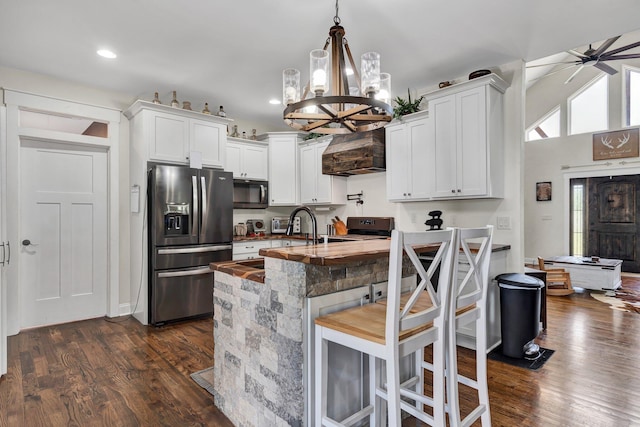 1033 Carter Rd SE, Old Fort, TN 37362 - kitchen with stainless steel refrigerator with ice dispenser, premium range hood, hanging light fixtures, dark hardwood / wood-style floors, and white cabinets