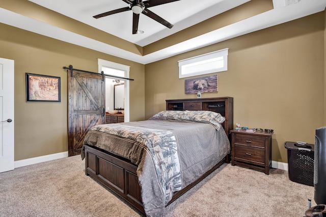 1033 Carter Rd SE, Old Fort, TN 37362 - bedroom with a raised ceiling, a barn door, light carpet, and ceiling fan