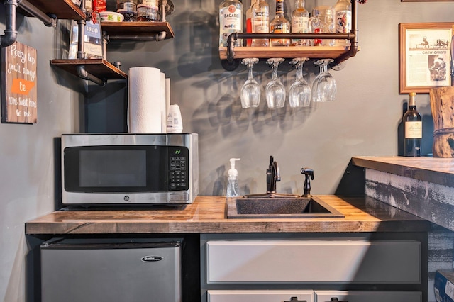 1033 Carter Rd SE, Old Fort, TN 37362 - bar with appliances with stainless steel finishes, sink, and butcher block countertops