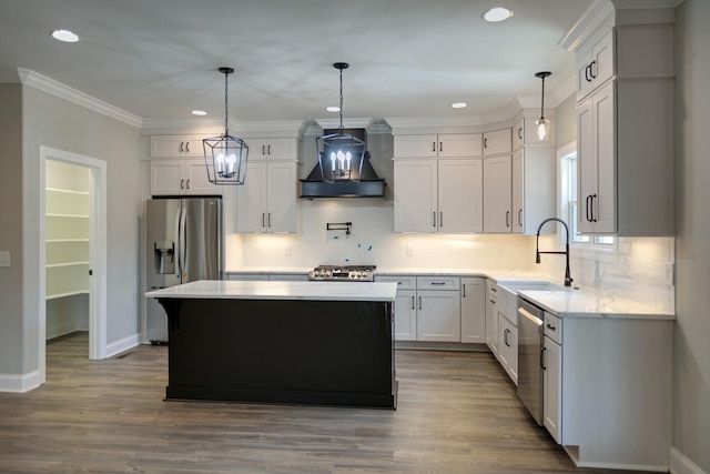 kitchen with custom range hood, a kitchen island, hanging light fixtures, and sink