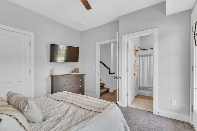 carpeted bedroom with ceiling fan and ensuite bathroom