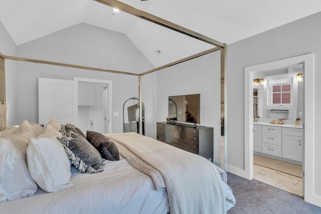 carpeted bedroom featuring ensuite bath and lofted ceiling