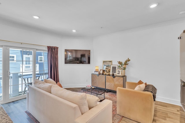 living room featuring light hardwood / wood-style flooring and crown molding