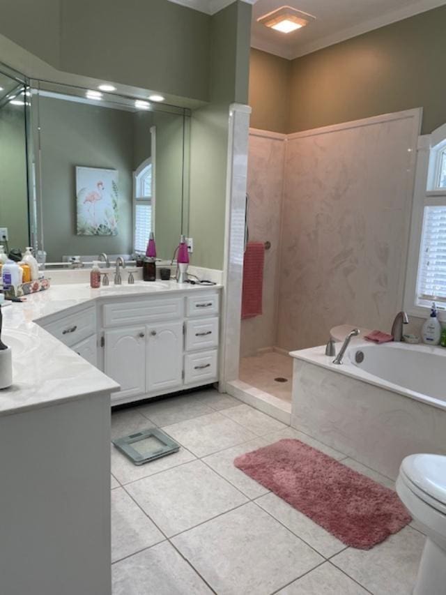 full bathroom featuring independent shower and bath, tile patterned flooring, vanity, ornamental molding, and toilet