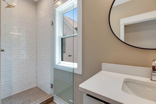 bathroom with a shower stall and vanity