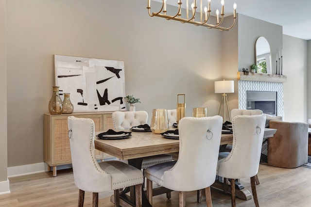 dining space featuring a chandelier and light wood-type flooring