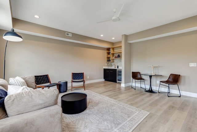 living area featuring recessed lighting, visible vents, baseboards, light wood-type flooring, and indoor wet bar