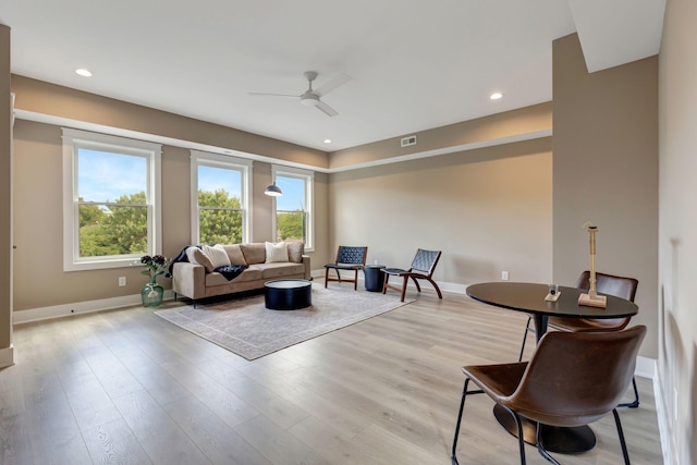 living area featuring light wood-type flooring, visible vents, baseboards, and recessed lighting