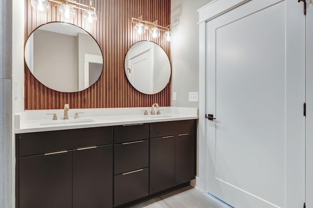 full bathroom with double vanity and a sink