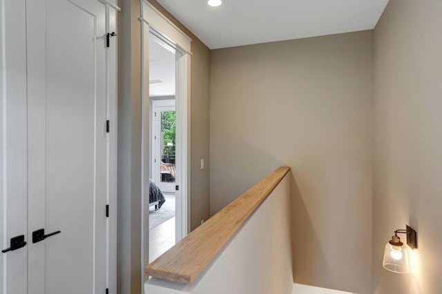 hall featuring recessed lighting and an upstairs landing