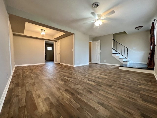 unfurnished living room featuring dark hardwood / wood-style floors and ceiling fan