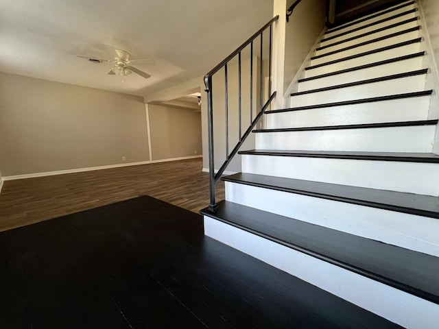 stairway featuring hardwood / wood-style floors and ceiling fan