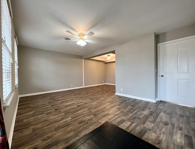 unfurnished room featuring ceiling fan and dark wood-type flooring