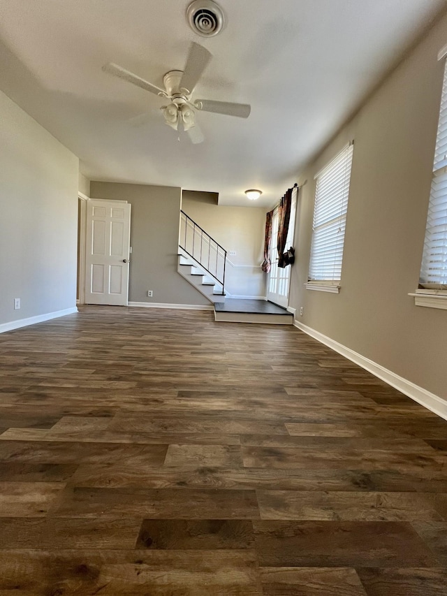 interior space with ceiling fan and dark hardwood / wood-style flooring