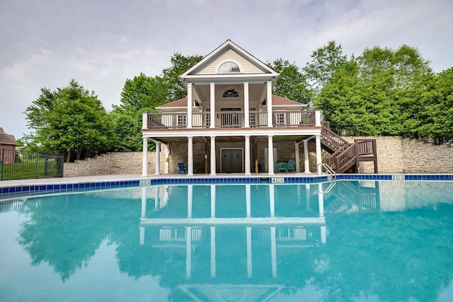 view of pool featuring a wooden deck and ceiling fan