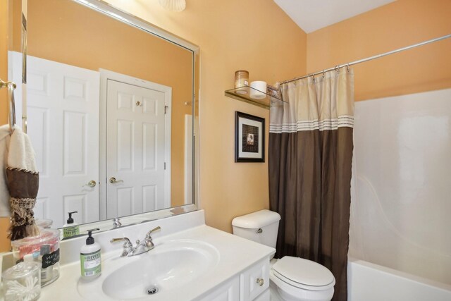 full bathroom with toilet, vanity, and shower / tub combo