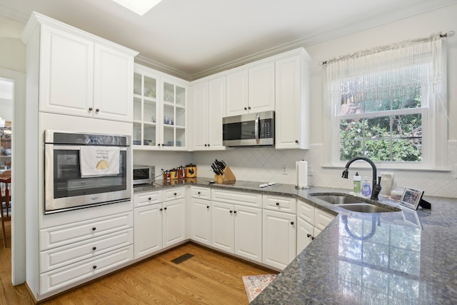 kitchen featuring sink, white cabinets, and appliances with stainless steel finishes