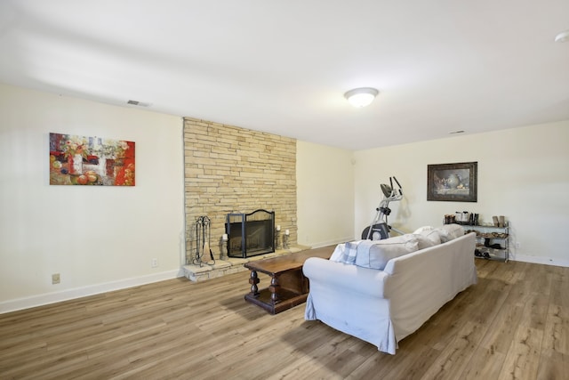 living room with light hardwood / wood-style flooring and a fireplace