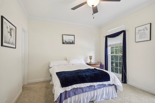 carpeted bedroom with ceiling fan and crown molding