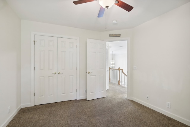 unfurnished bedroom featuring a closet, ceiling fan, and dark carpet