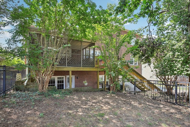 rear view of property featuring a garage