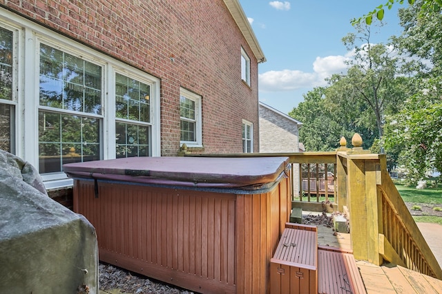 wooden deck with a hot tub