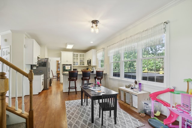 interior space featuring crown molding, hardwood / wood-style floors, and sink