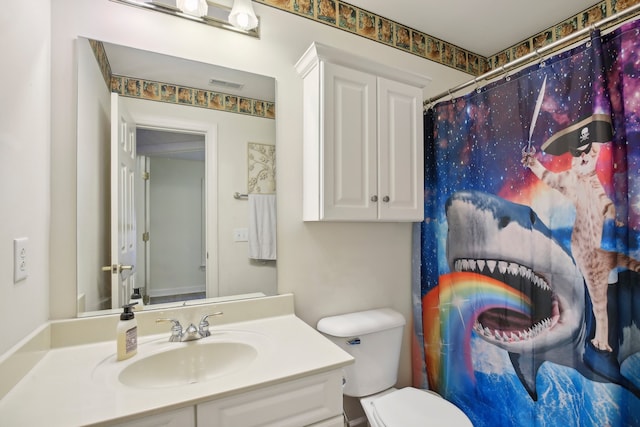 bathroom featuring vanity, toilet, and a shower with curtain