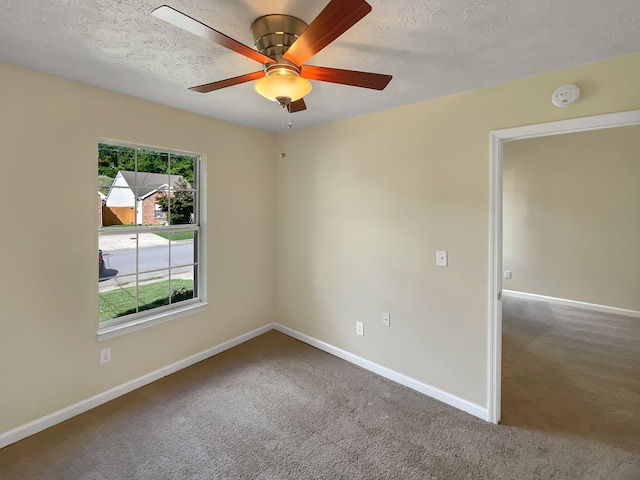 empty room featuring carpet flooring, a textured ceiling, and ceiling fan