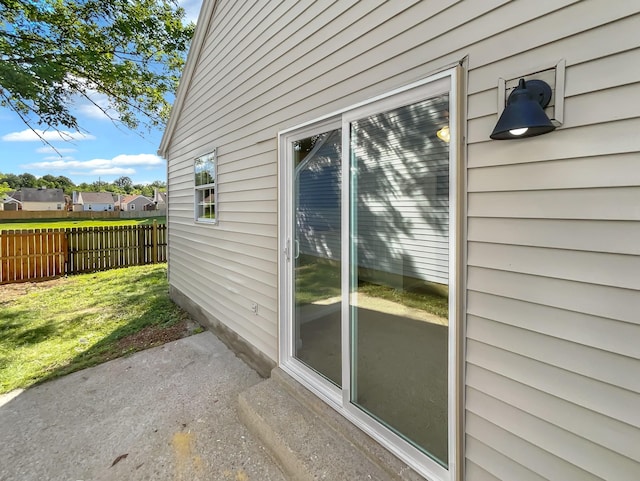 view of side of home with a yard