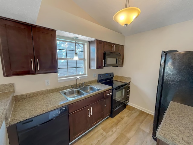 kitchen featuring pendant lighting, black appliances, sink, light wood-type flooring, and dark brown cabinetry