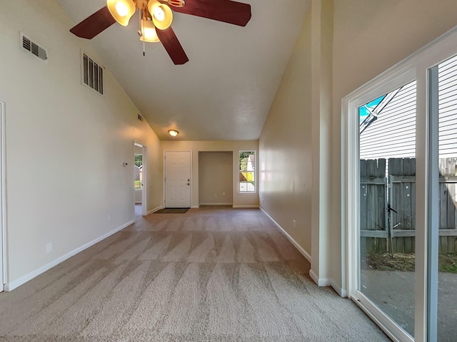 interior space featuring light carpet, ceiling fan, and high vaulted ceiling