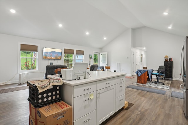 kitchen featuring wood-type flooring, a kitchen island with sink, a wealth of natural light, and white cabinets