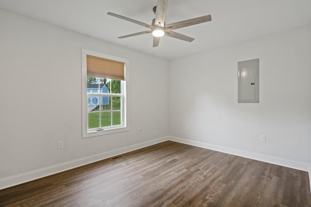 spare room with ceiling fan, dark hardwood / wood-style floors, and electric panel