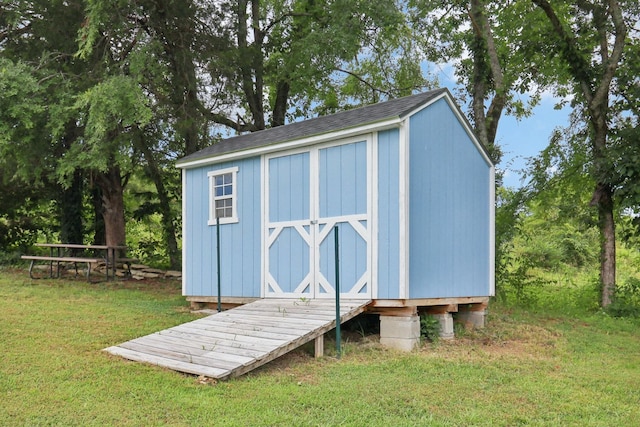 view of outbuilding featuring a yard