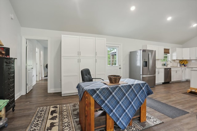 dining area with lofted ceiling, dark hardwood / wood-style flooring, and sink