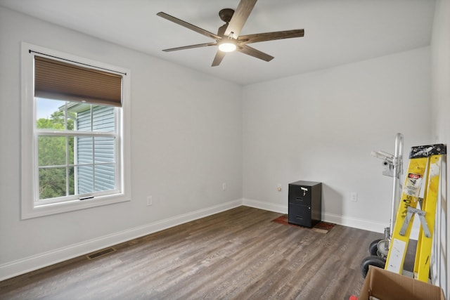 spare room with dark hardwood / wood-style floors and ceiling fan