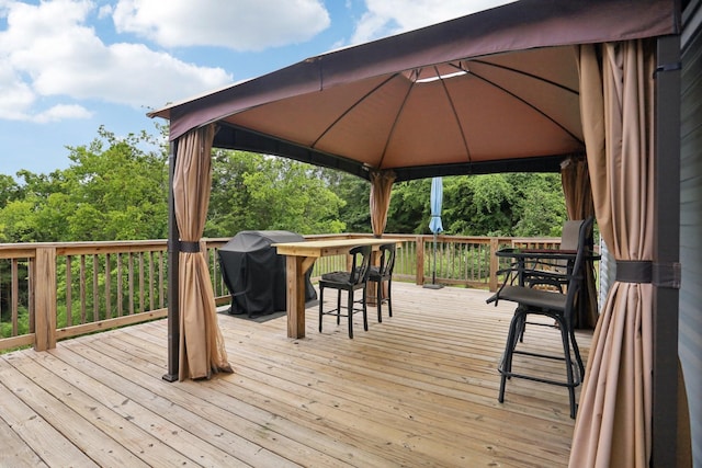 wooden deck with a grill and a gazebo