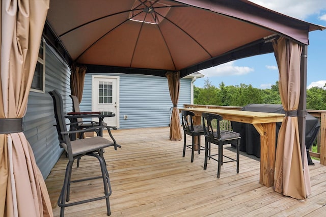 wooden terrace featuring a bar and a gazebo