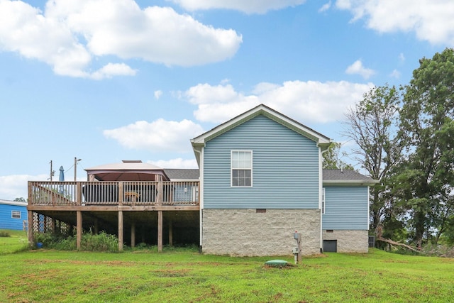 rear view of property featuring a gazebo and a yard